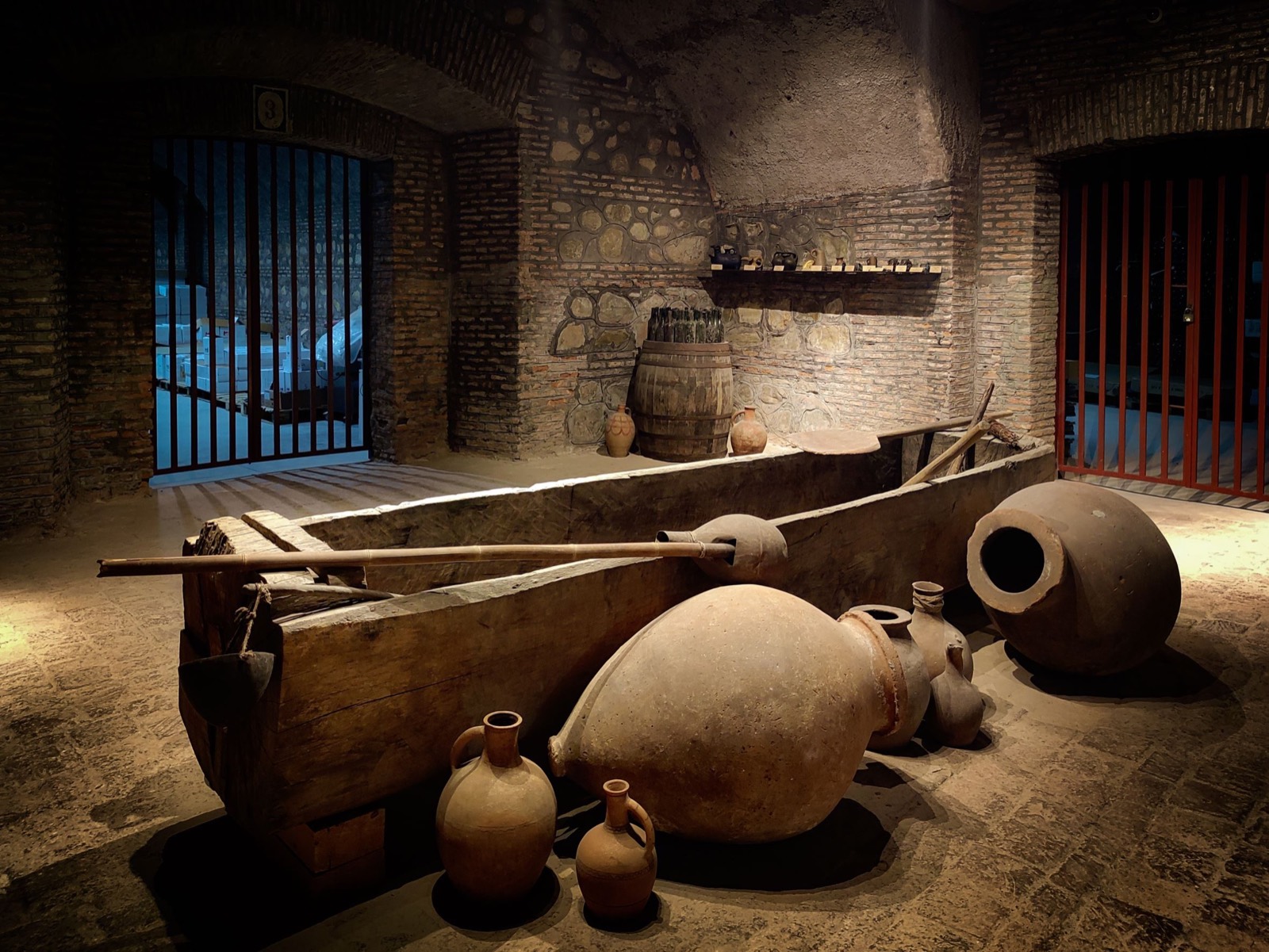 Traditional Kindzmarauli Marani hall with qvevri set into the floor
