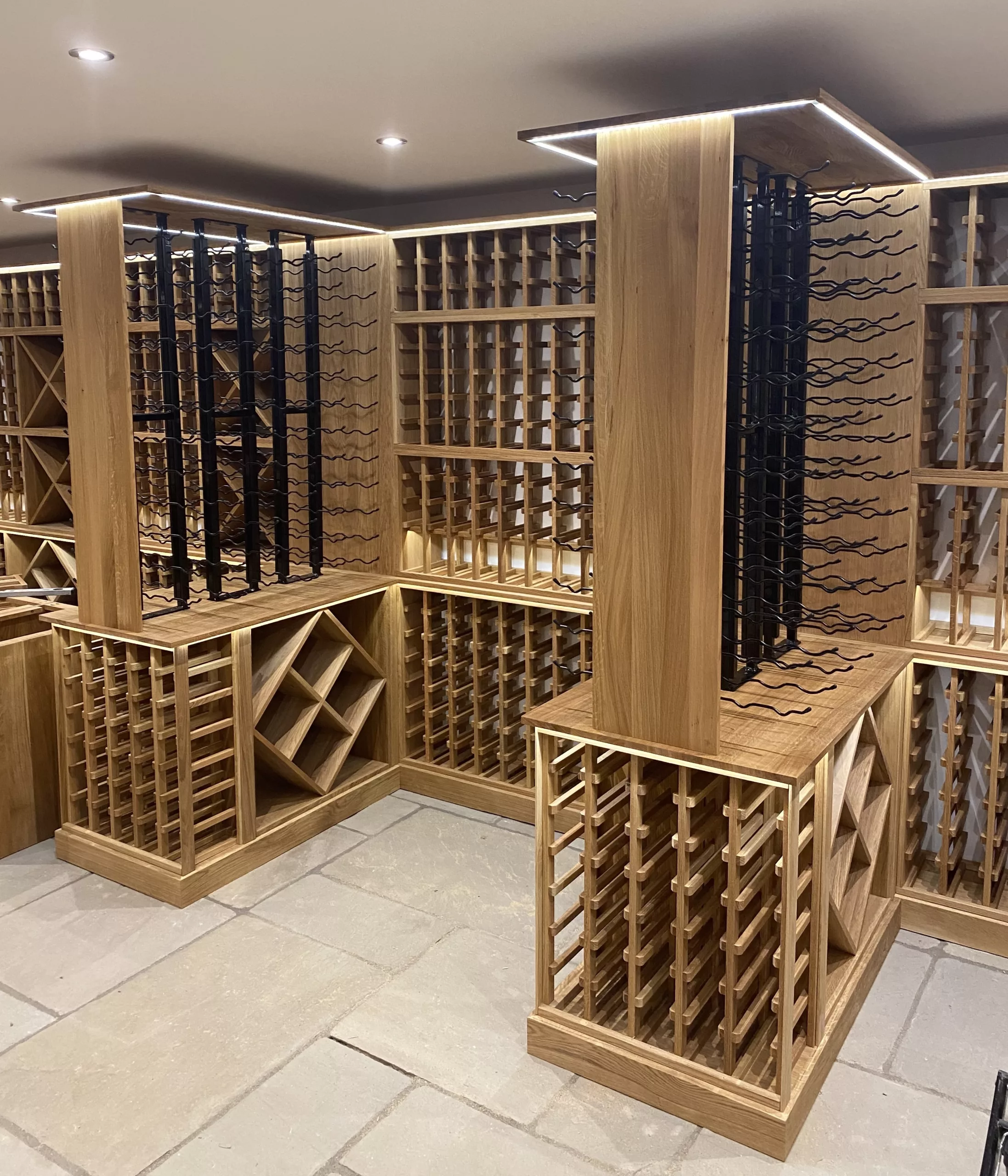 Detailed oak bottle storage with black metal display racks